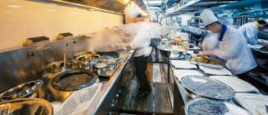 Motion image of chefs in a commercial kitchen.